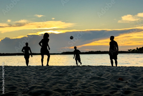 Obraz Four men playing soccer on the beach in Boipeba during sunset