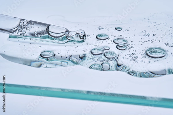 Fototapeta Serum with peptides on a blue background with a pipette. The texture.