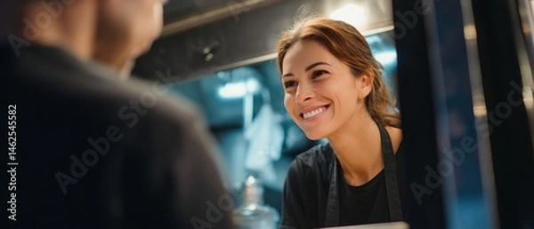 Obraz A smiling waitress taking order in a restaurant