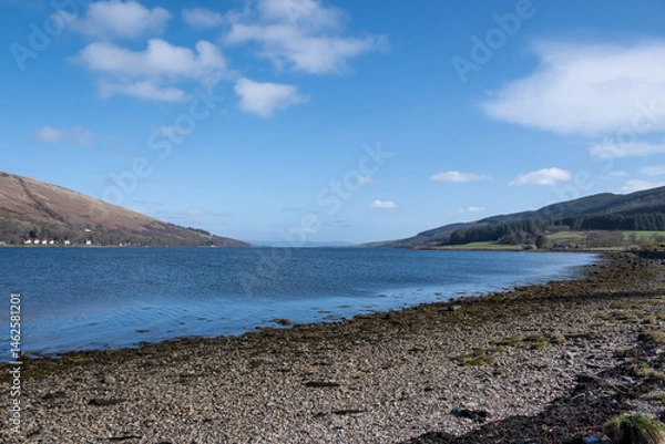 Fototapeta stunning rugged rocky Scottish coastline landscape from Bute island looking into the clear cold blue water Firth of Clyde on a gorgeous sunny day.