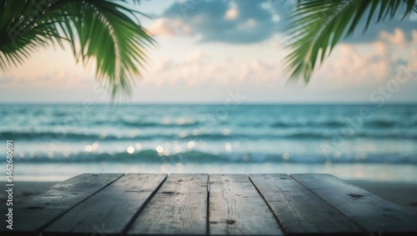 Fototapeta Bare wooden table with a blurred ocean and sky backdrop