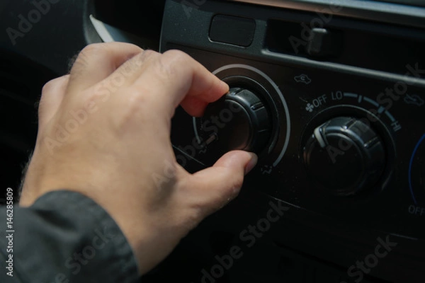 Fototapeta Close-up of man open switch air in car