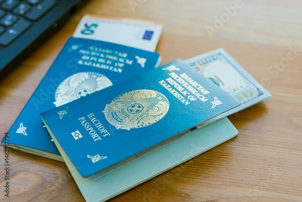 Fototapeta Two passports of the Republic of Kazakhstan and banknotes in denominations of euro and dollar. High quality photo