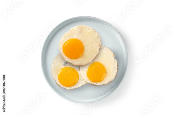 Fototapeta Fried egg on ceramic plate on white background. Top view