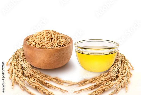 Fototapeta Glass bowl of rice bran oil with paddy rice in wooden bowl isolated on white background.
