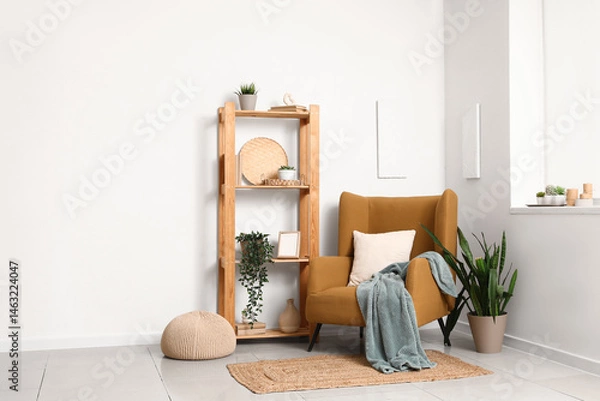 Fototapeta Interior of living room with armchair, shelf unit and plants
