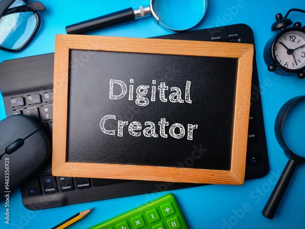 Obraz Top view wooden board and keyboard with the word Digital Creator on a blue background