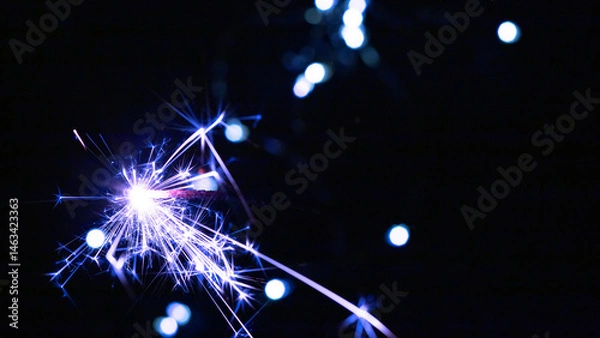 Obraz Happy New Year and Merry Christmas, Glittering burning sparkler against blurred bokeh light background