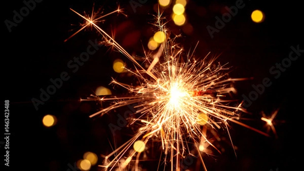 Obraz Happy New Year and Merry Christmas, Glittering burning sparkler against blurred bokeh light background