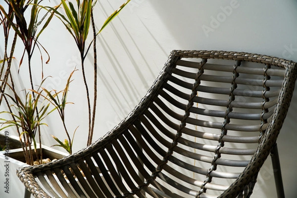 Obraz rattan chair on white wall background, interior design concept.