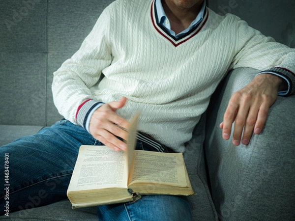 Fototapeta An adult man reading a book