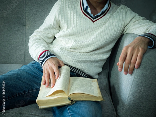 Fototapeta An adult man reading a book