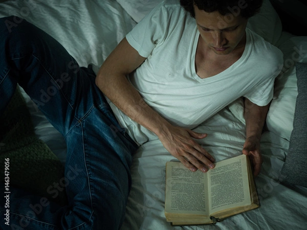 Fototapeta An adult man reading a book