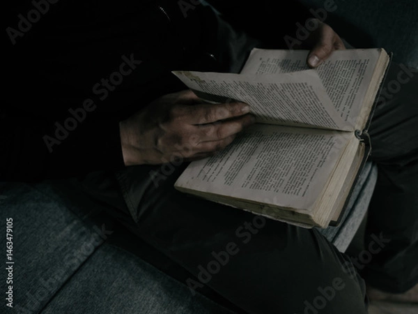 Fototapeta An adult man reading a book