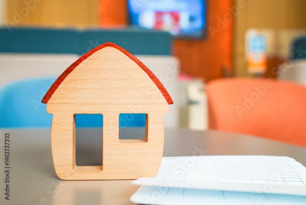 Fototapeta House model and bank book are placed on the table in the bank and thinking about applying for a home loan, placing collateral for the loan.
