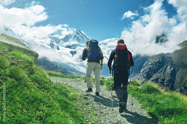 Obraz hikers with backpacks on the trail in the Apls, Swiss mountains. Trek near Matterhorn mount, mountain ridge on background