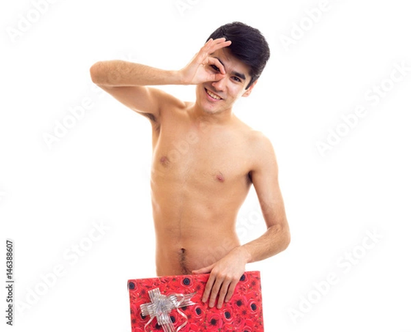 Obraz Undressed young man holding present