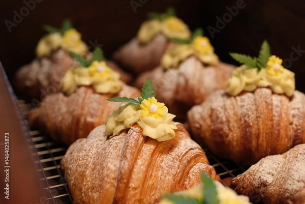 Obraz Yummy freshly croissant, sliced almonds, with custard filling cut, close up. croissants with durian and creamy yellow cream