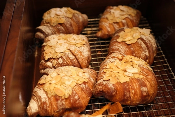 Obraz Homemade Almond Croissants freshly baked and cooling on rack. High quality photo