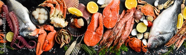 Obraz Seafood. Wide banner. Fresh fish, shrimp, oysters, lobster and octopus on slate black table. Top view.