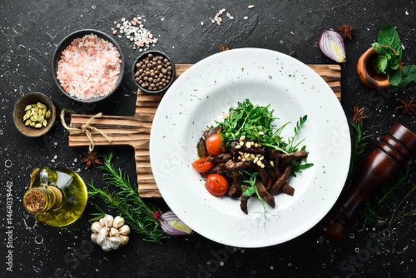 Obraz Fresh salad with veal: arugula, veal, pine nuts and eggplant. Healthy food. On a white plate. Rustic style.