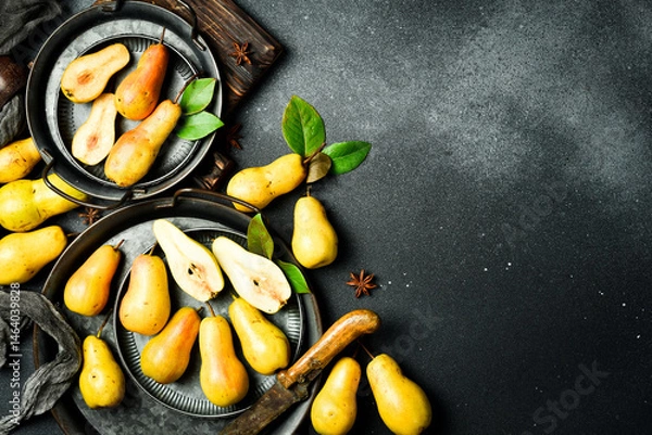Obraz pears in a plate and slices of pears top view. Gray stone table. Autumn fruits.