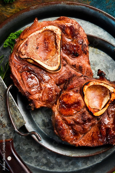 Obraz Veal Ossobuco Grilled steak with sea salt, butter and spices. Juicy steak grilled. Top view.