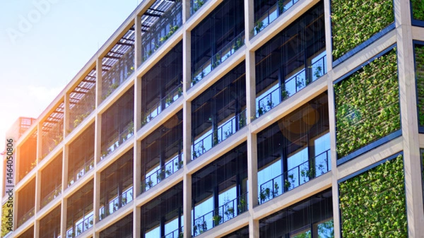 Fototapeta Green office building with plants on the facade. Ecology and green living in city, urban environment concept. Eco architecture. 