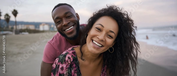 Fototapeta Happy couple enjoying a beach day at sunset with smiles and laughter