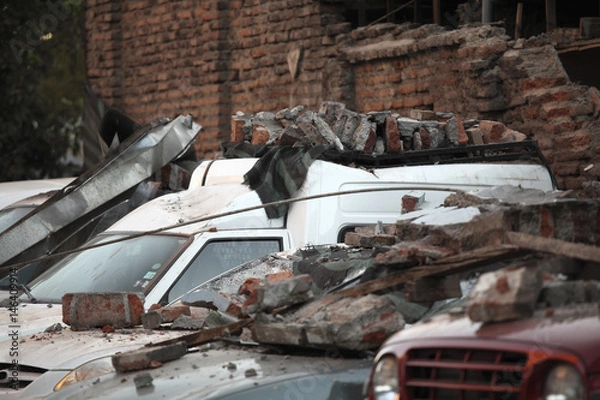 Fototapeta Rubble over cars during an earthquake in Chile.