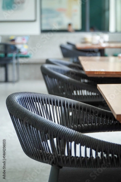 Fototapeta Empty tables and chairs in a restaurant, selective focus, shallow DOF