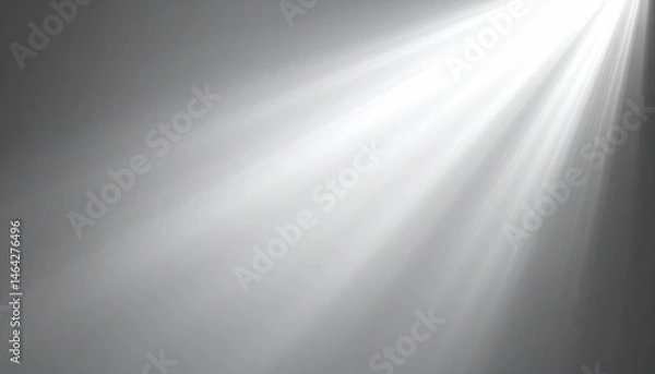 Fototapeta A soft beam of light breaks through a muted gray background, creating a serene and ethereal atmosphere