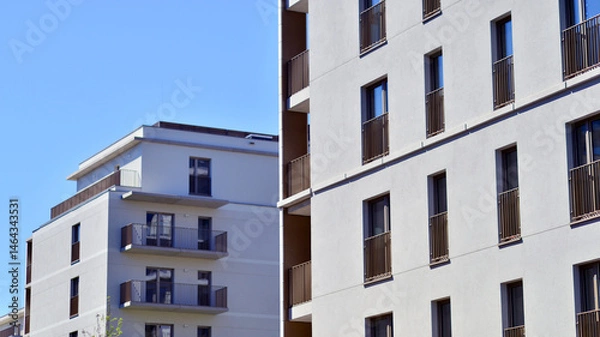 Fototapeta Modern new residential apartment house building complex. Exterior view of modern apartment building. New construction apartment or condo complex.