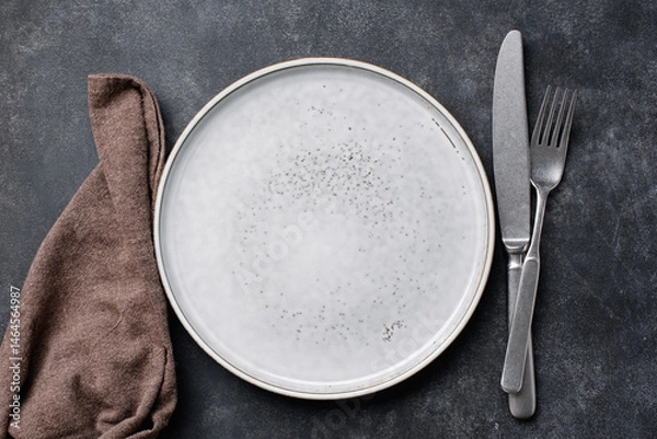 Fototapeta Empty plate, cutlery and table cloth. Top view, copy space