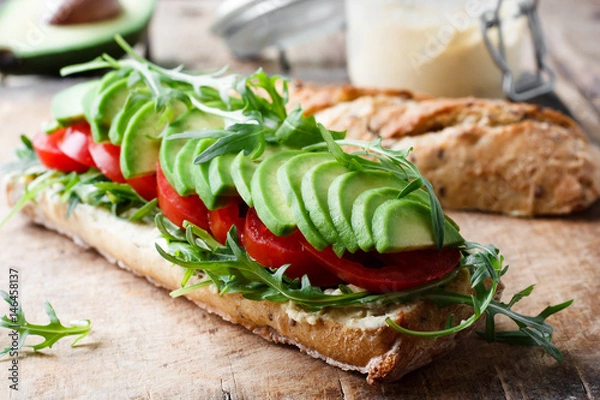 Fototapeta Vegan sandwich with avocado and tomatoes