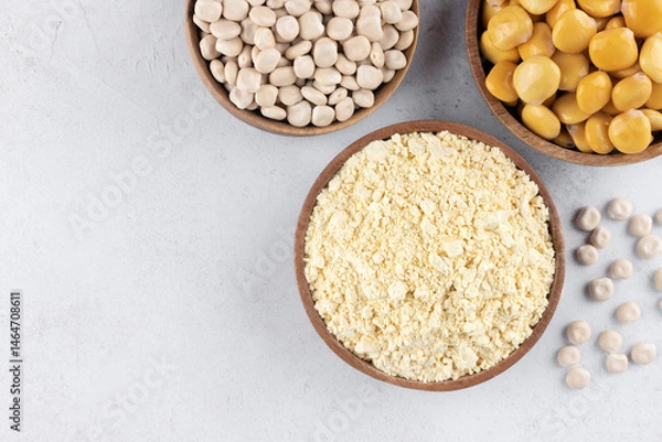 Obraz Gluten free lupine flour, dry lupine beans, protein rich snack of pickled lupine beans on white background. Top view.