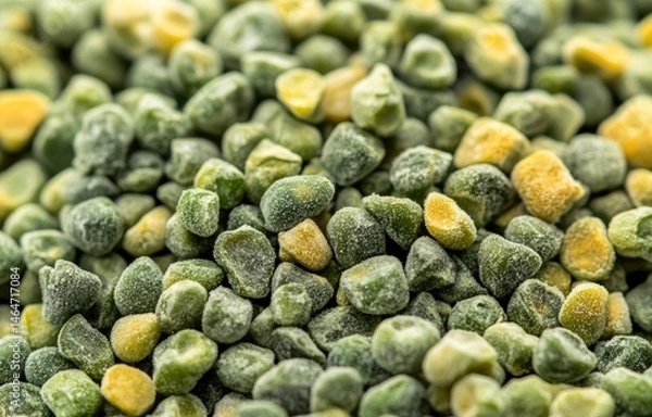 Fototapeta Close-up of frozen peas, showing many small, slightly uneven, green and yellow peas.  Frozen vegetable texture