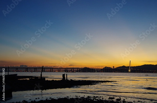 Fototapeta colorful sunset at Lau Fau Shan, Hong Kong. The bridge at the background links Hong Kong and China.