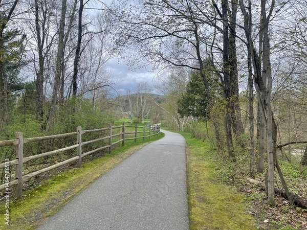 Obraz A recreational bike and walking path winds past a split post fence in rural Vermont