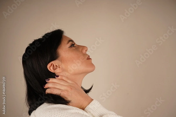 Obraz Beautiful image of a woman of European appearance. Calm close-up of a woman standing in a relaxed pose, radiating natural charm. Side view of a young woman.