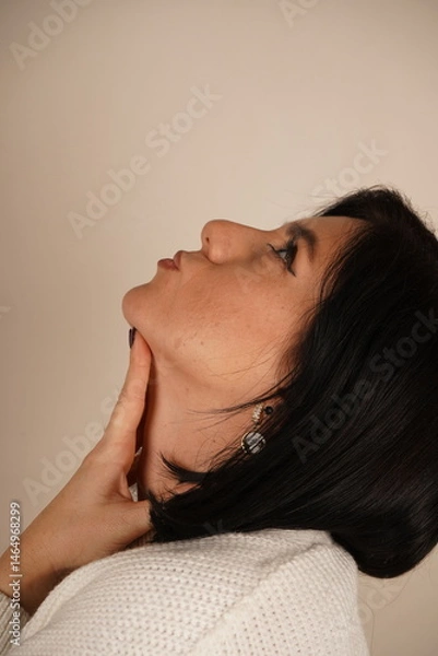 Obraz Her natural beauty and soft expression convey peace and tranquility. The composition highlights simplicity and ease. A close-up of a woman's face showcases her calm and relaxed demeanor.