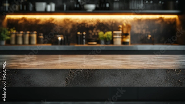 Fototapeta Empty concrete kitchen countertop for product display photography, against a modern industrial kitchen with illuminated lights.