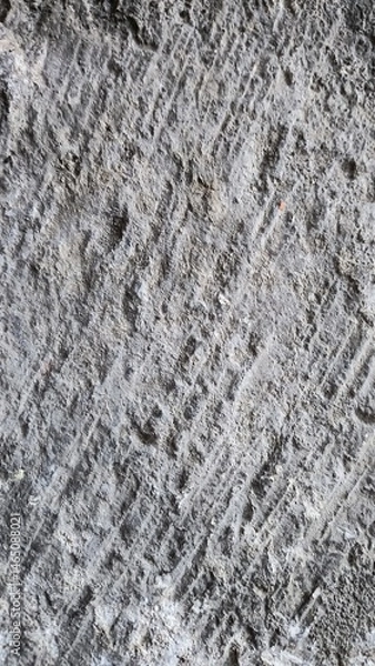 Obraz Texture of rough concrete wall with visible patterns and grooves at construction site during daytime