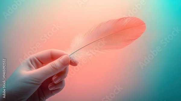 Obraz Delicate feather held in a gloved hand, vibrant colors.