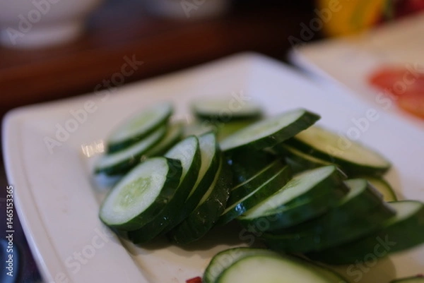 Obraz Heap of fresh sliced Cucumbers on an old wooden table. High quality photo