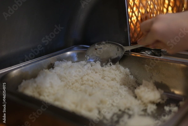 Obraz A steaming pot of freshly cooked white rice Perfect for any meal and ready to be served. High quality photo