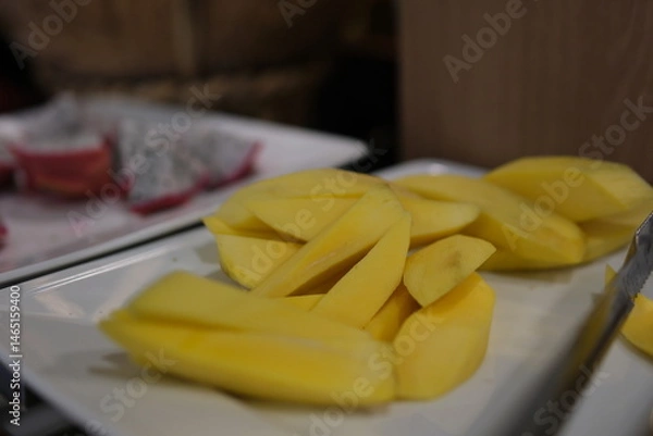 Obraz Fresh and ripe mango fruit slice on wooden bowl . High quality photo