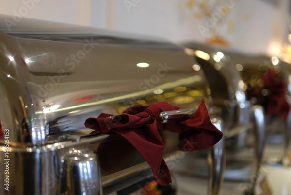 Obraz Bustling Cafeteria Serving Line During Lunchtime Offering a Variety of Dishes. iron with a burgundy bow