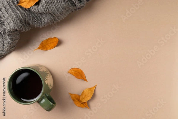 Fototapeta Cup of tea with leaves on beige background. Flat lay, top view. Copy space