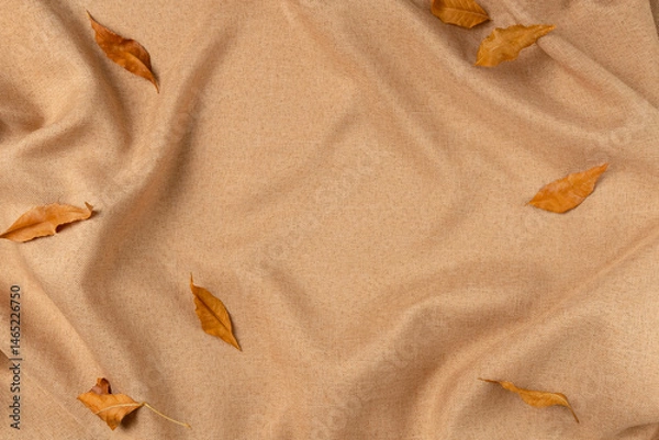 Obraz Brown fabric with leaves as concept background. Copy space